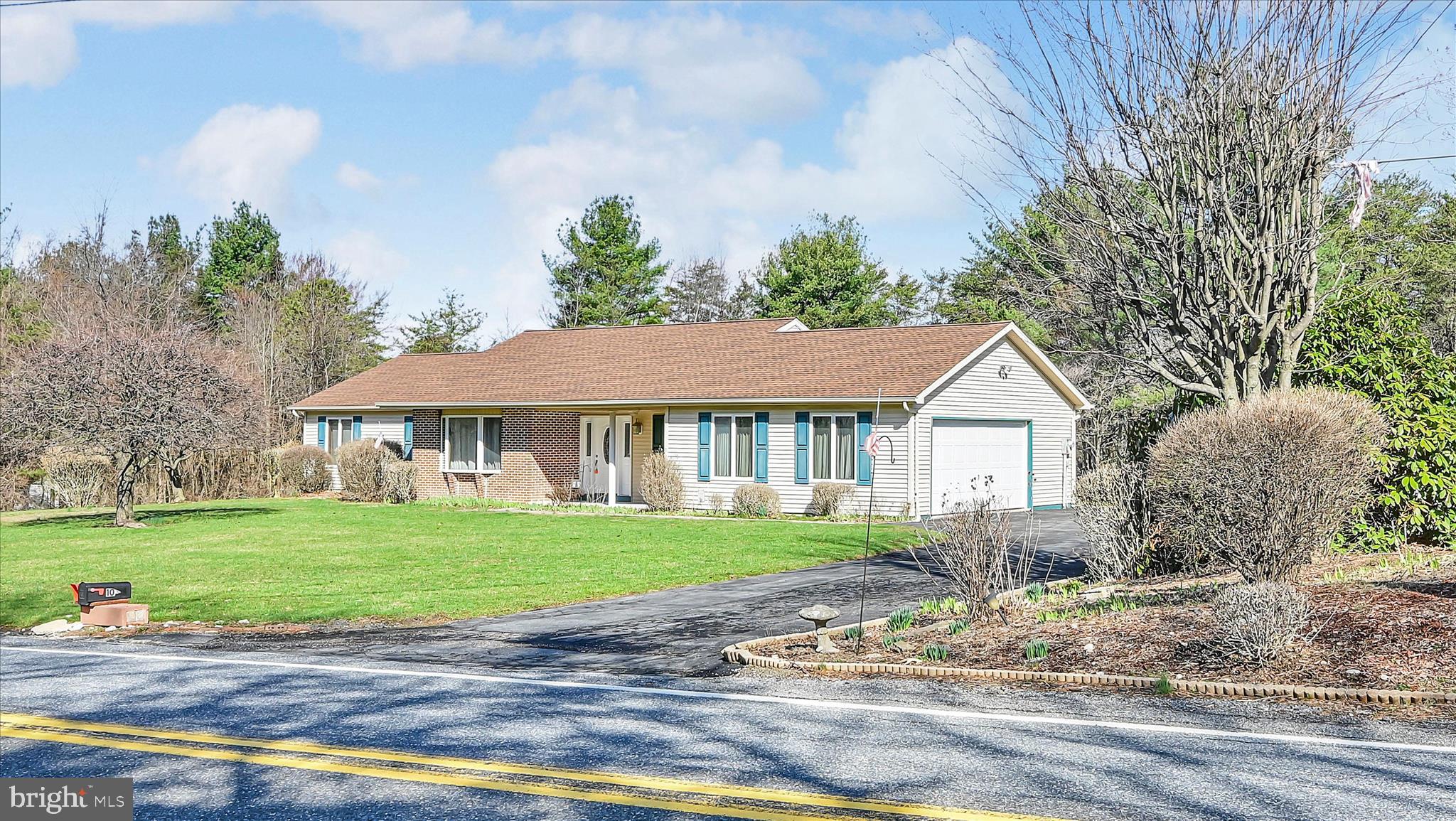 1039 Summer Hill Road Auburn, PA 17922 - Photo 5 of 40 a front view of a house with a garden