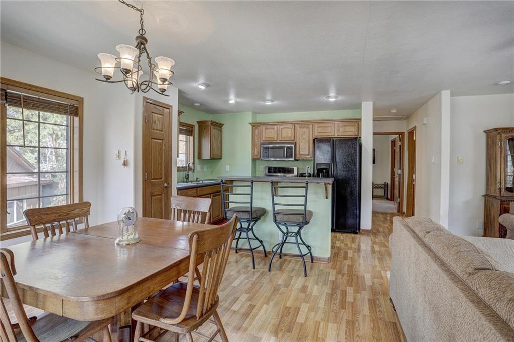 47 West Hansen Road Keystone, CO 80435 - Photo 14 of 35 a dining room filled chandelier and wooden floor