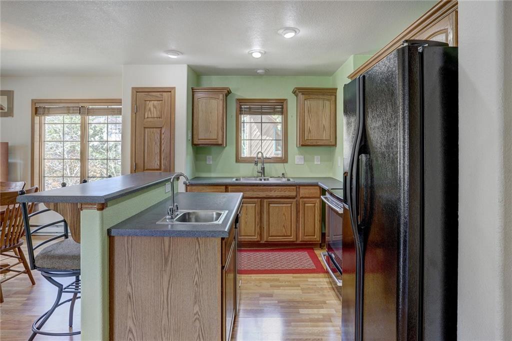 47 West Hansen Road Keystone, CO 80435 - Photo 18 of 35 a kitchen with a refrigerator a sink and a stove top oven