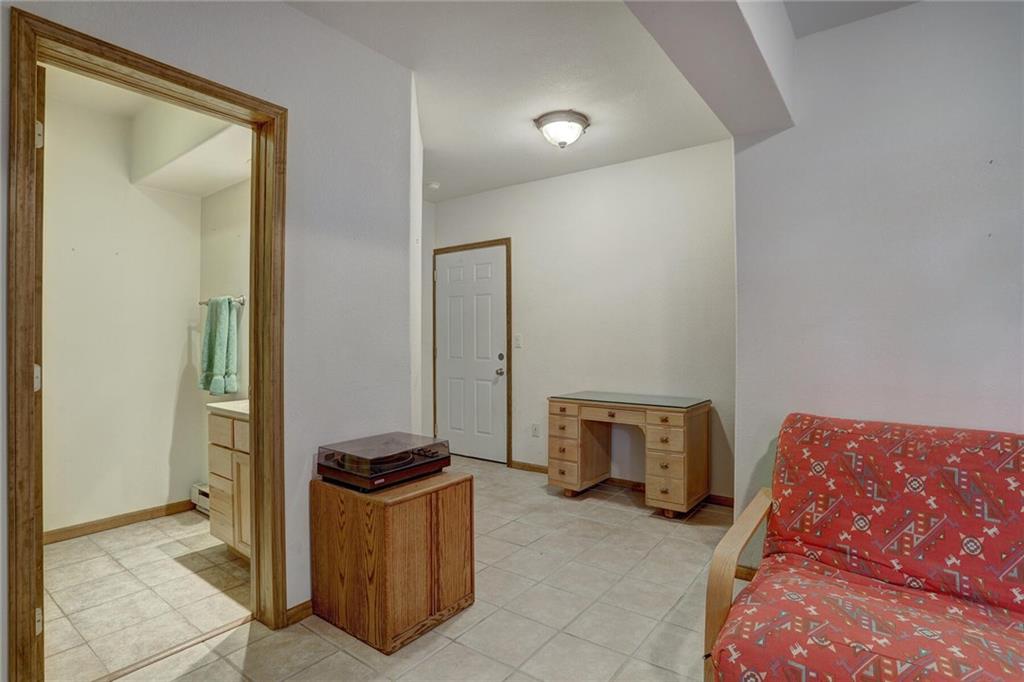 47 West Hansen Road Keystone, CO 80435 - Photo 26 of 35 a living room with a couch and a stove next to a window