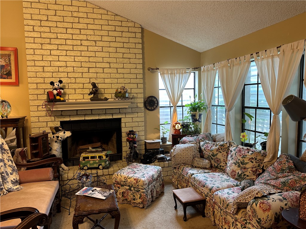 7322 Pepper Ridge Road Corpus Christi, TX 78413 - Photo 4 of 11 a living room with furniture and a fireplace
