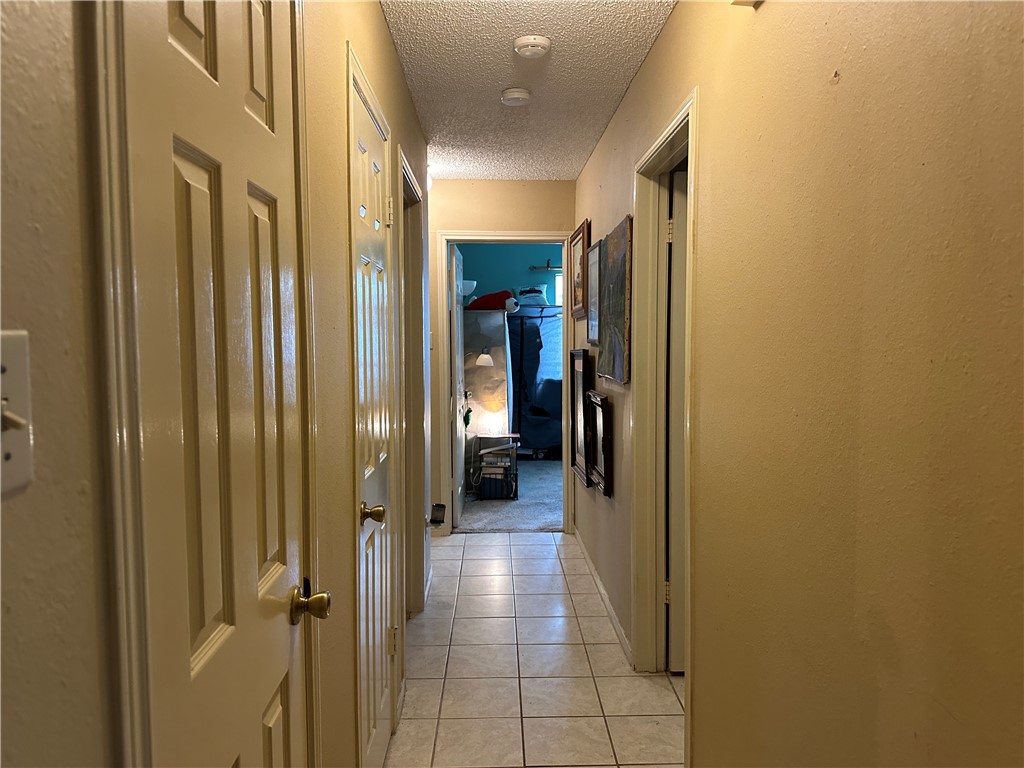 7322 Pepper Ridge Road Corpus Christi, TX 78413 - Photo 7 of 11 a view of a hallway with wooden shelves