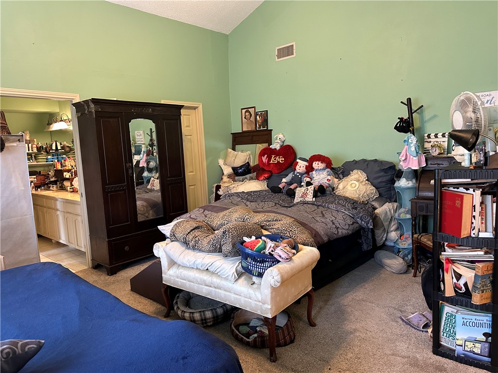 7322 Pepper Ridge Road Corpus Christi, TX 78413 - Photo 9 of 11 a bedroom with a bed and wooden floor