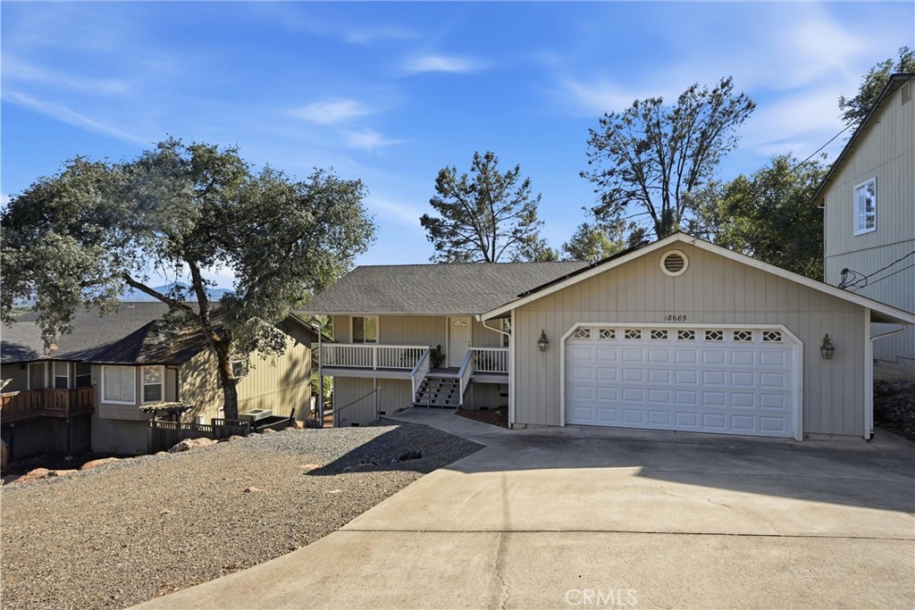 18685 Oak Grove Road Hidden Valley Lake, CA 95467 - Photo 32 of 52 a view of a white house with a yard and large tree