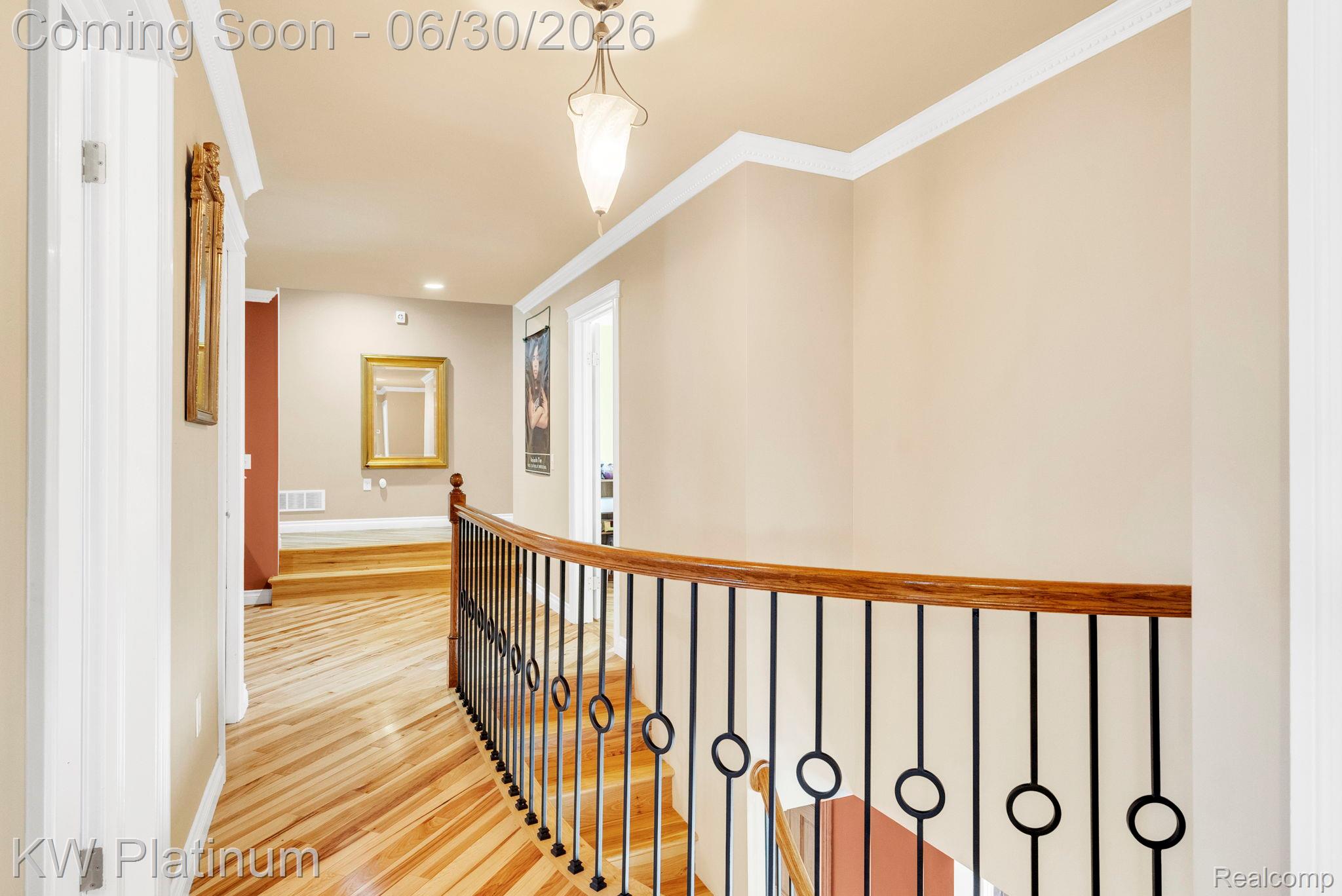 2235 South Lake Shore Road Harbor Beach, MI 48441 - Photo 28 of 99 Upper-level hallway featuring a curved iron baluster railing with a wood-finish handrail