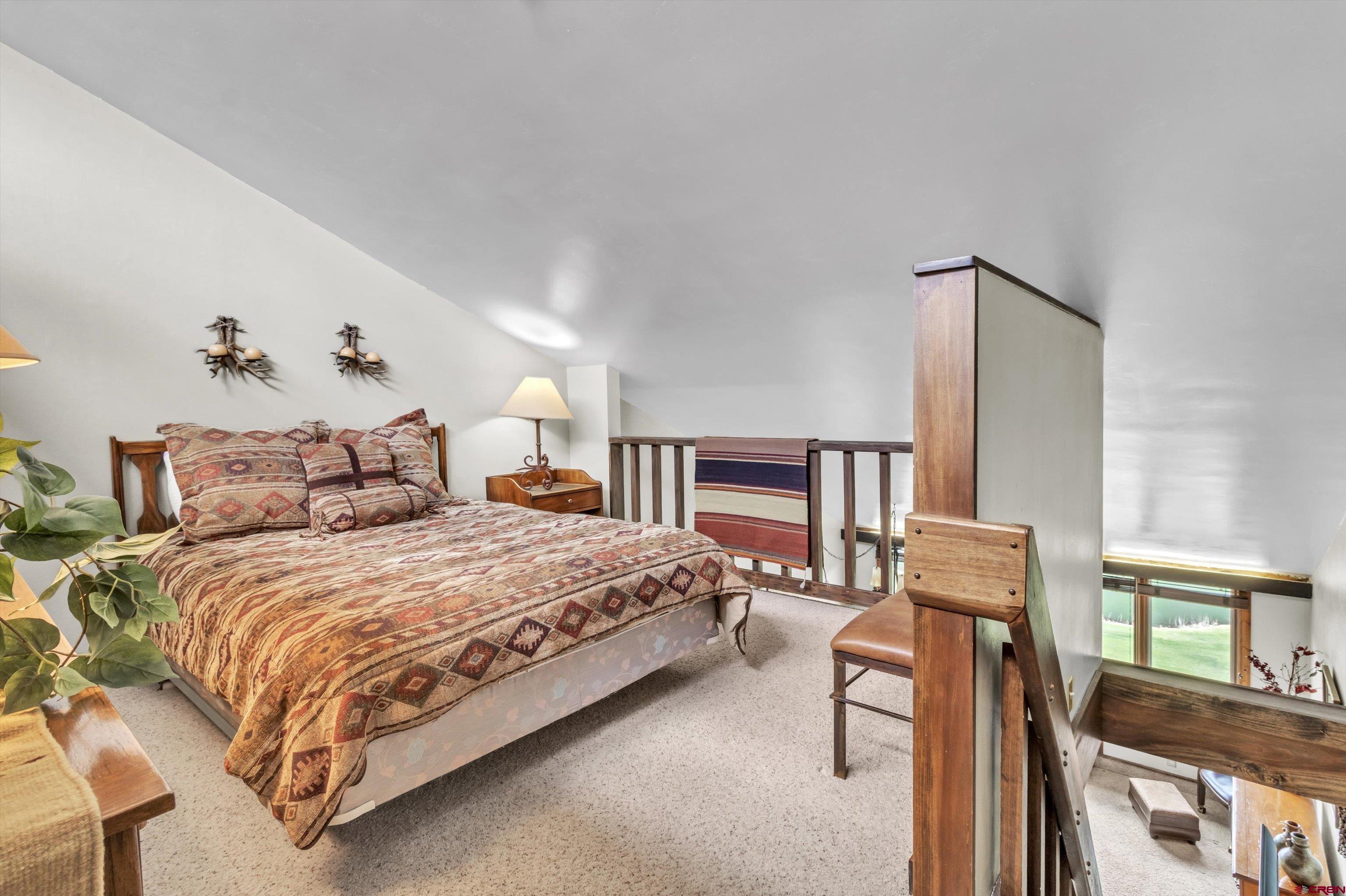 314 Tamarron Drive, Unit 511 Durango, CO 81301 - Photo 11 of 36 a bedroom with a bed a dresser and book shelf