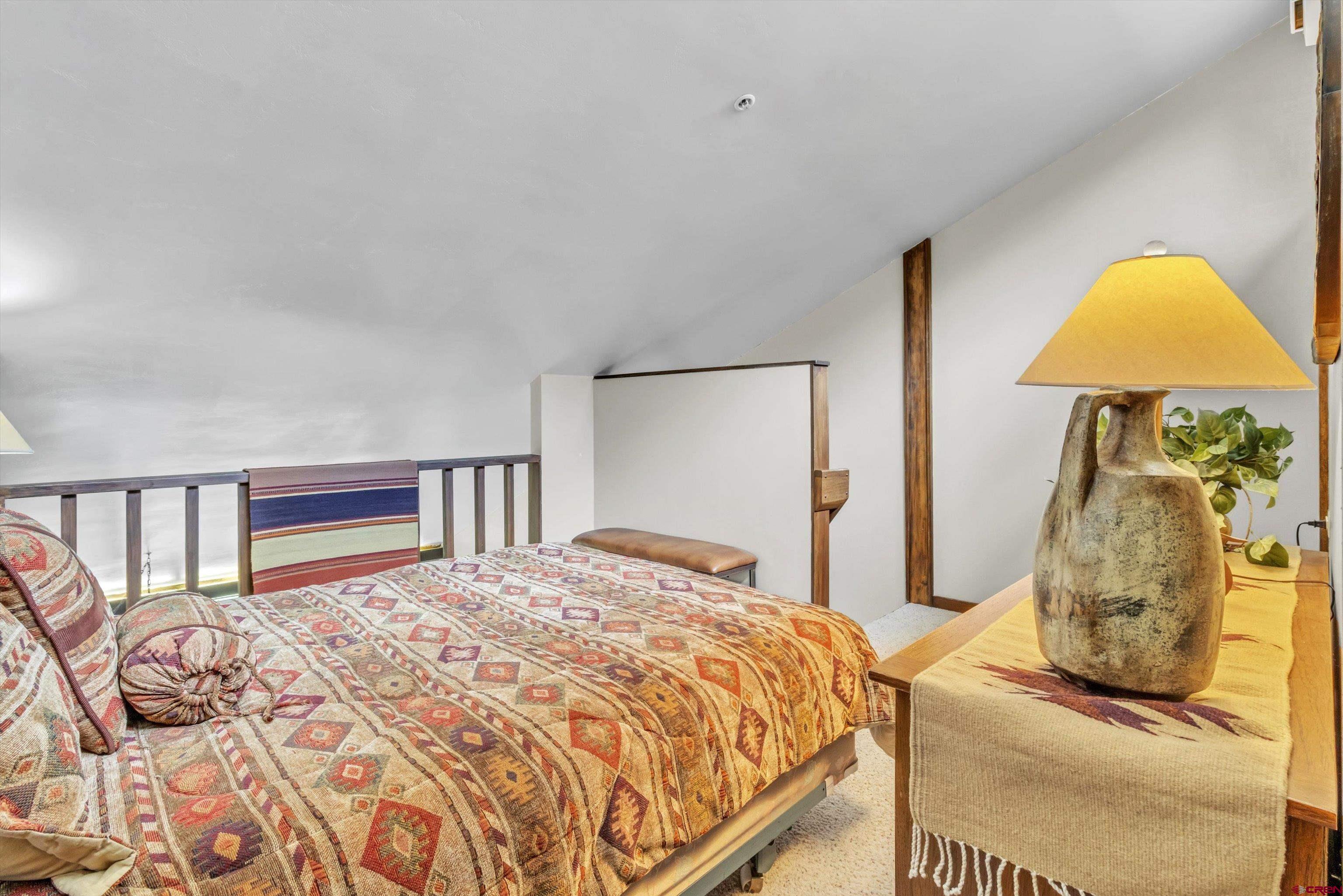 314 Tamarron Drive, Unit 511 Durango, CO 81301 - Photo 13 of 36 a bedroom with a bed and a painting on the wall