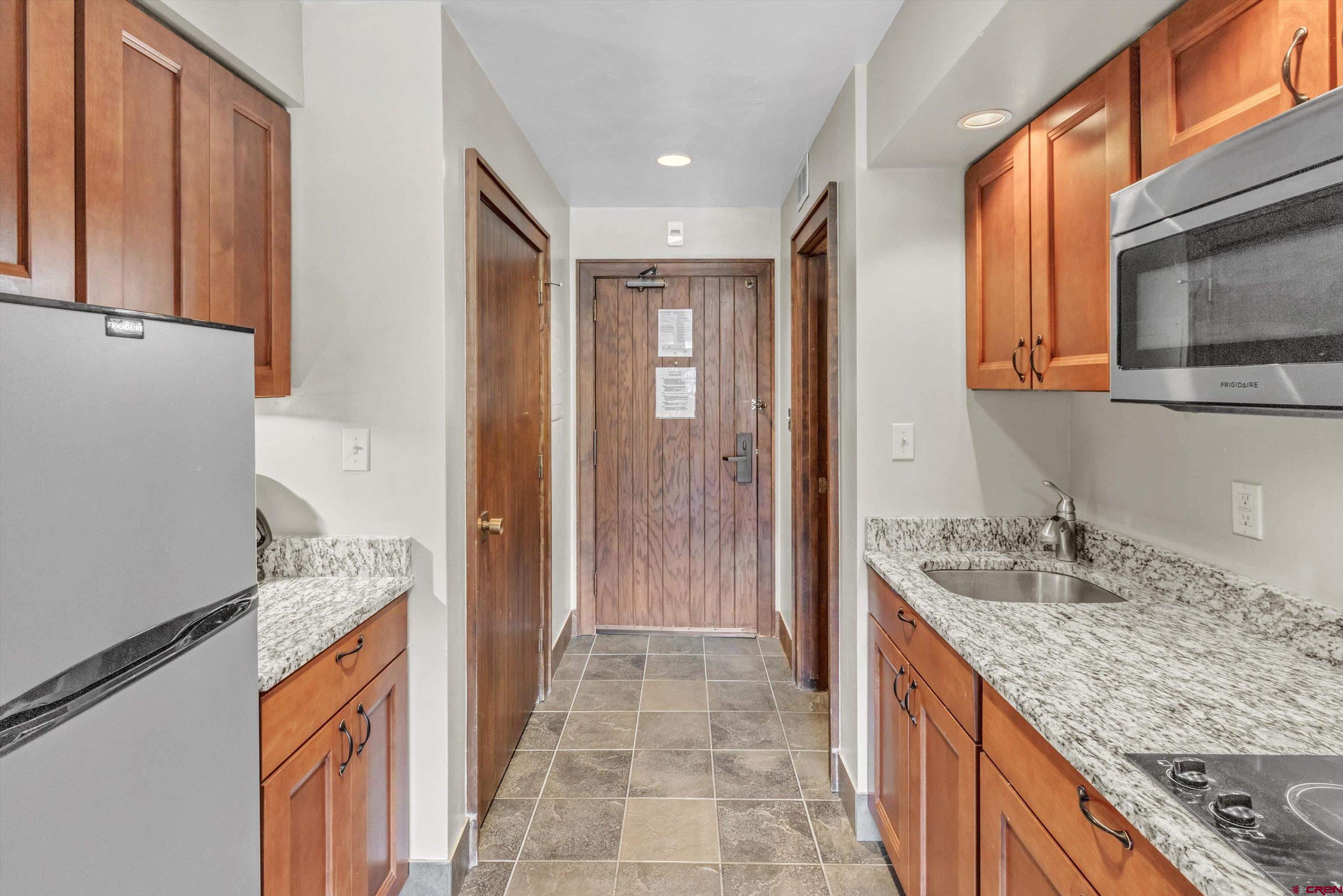 314 Tamarron Drive, Unit 511 Durango, CO 81301 - Photo 14 of 36 a bathroom with a granite countertop sink a mirror and shower
