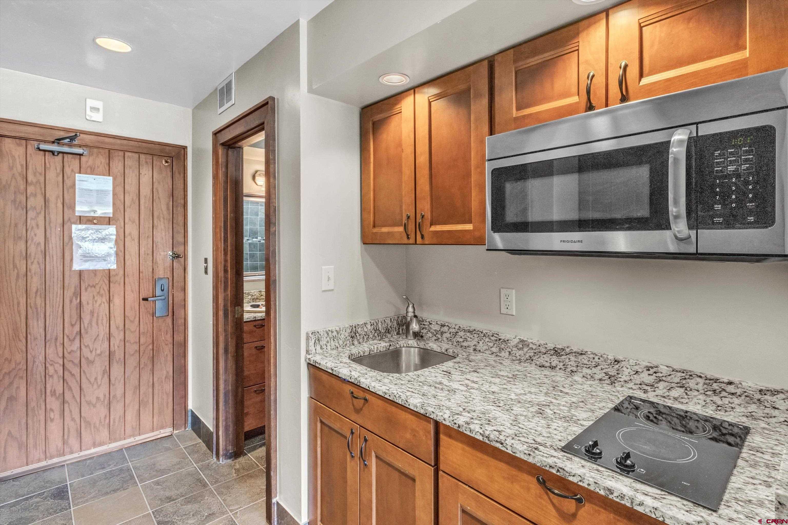 314 Tamarron Drive, Unit 511 Durango, CO 81301 - Photo 18 of 36 a kitchen with a sink and cabinets