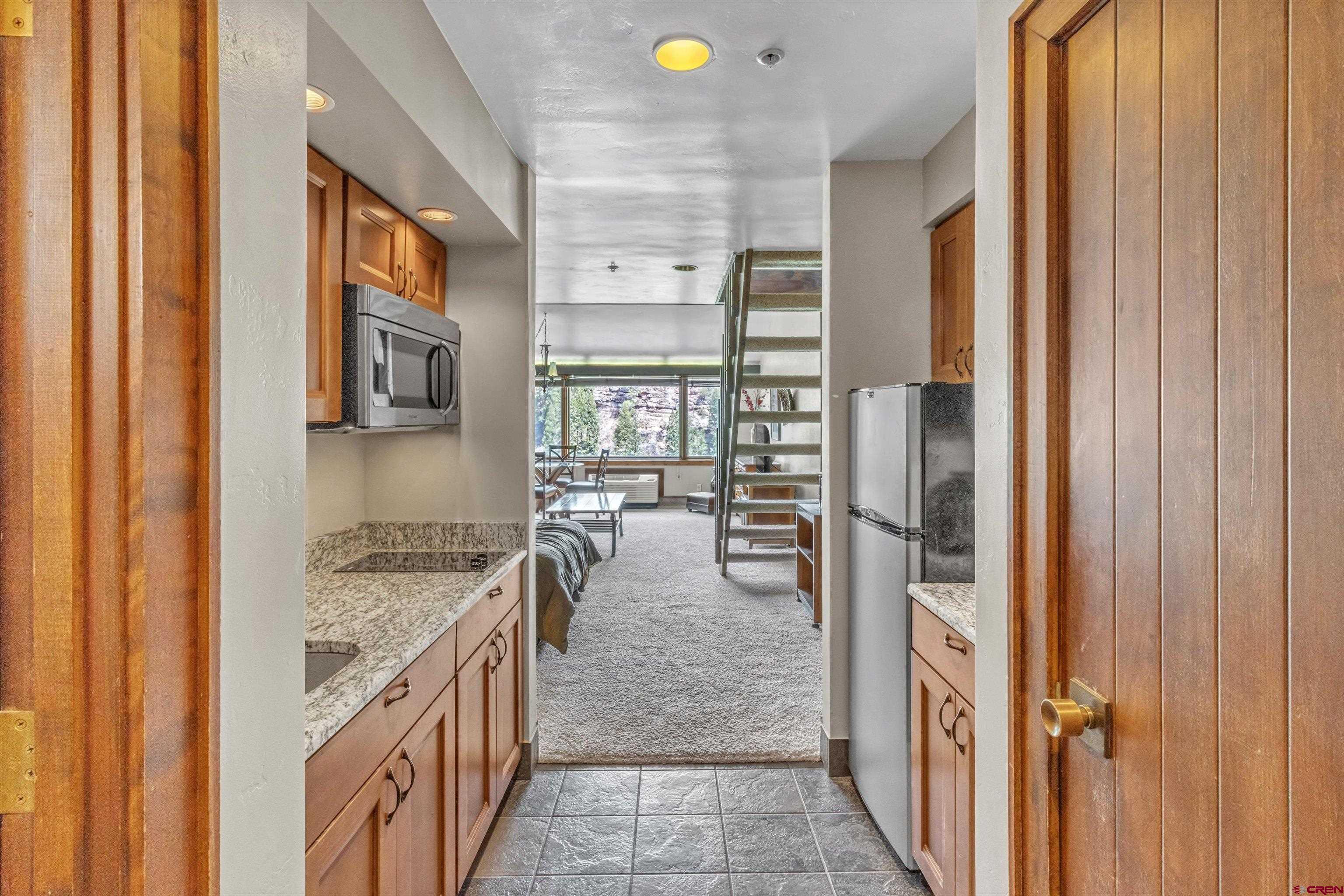 314 Tamarron Drive, Unit 511 Durango, CO 81301 - Photo 2 of 36 a kitchen with a stove and a refrigerator