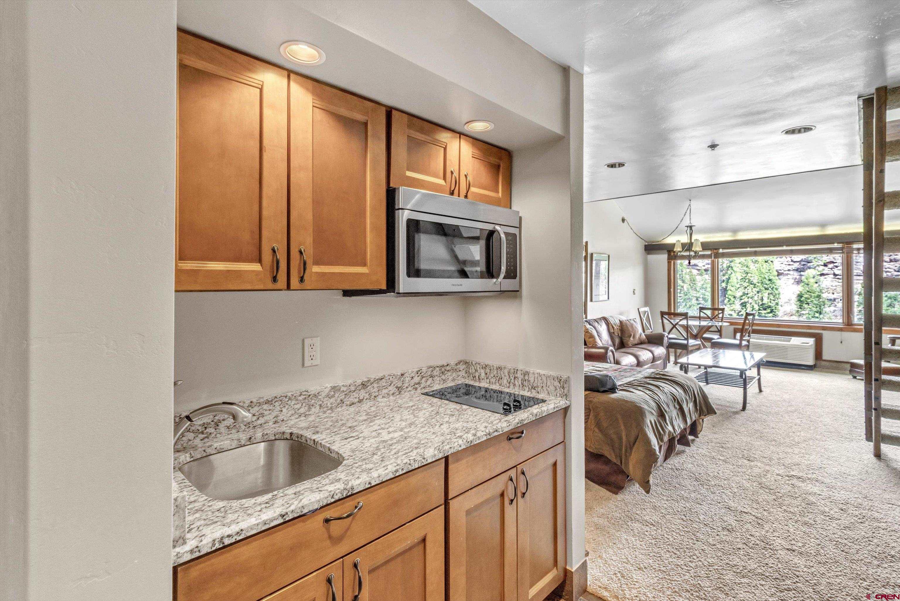 314 Tamarron Drive, Unit 511 Durango, CO 81301 - Photo 3 of 36 a kitchen with sink refrigerator and cabinets