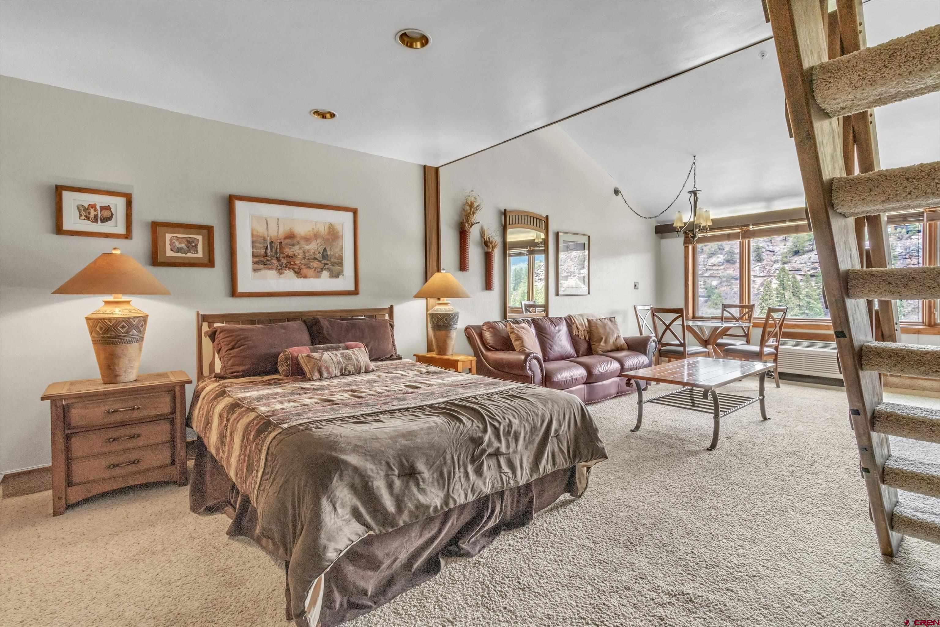 314 Tamarron Drive, Unit 511 Durango, CO 81301 - Photo 4 of 36 a spacious bedroom with a bed a couch and large window