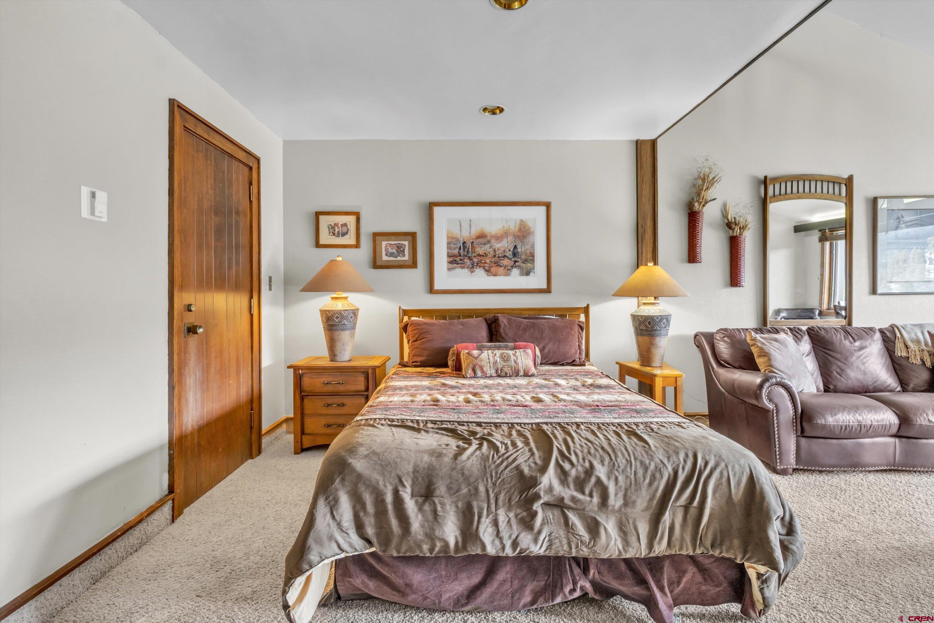 314 Tamarron Drive, Unit 511 Durango, CO 81301 - Photo 5 of 36 a bedroom with a bed and wooden floor