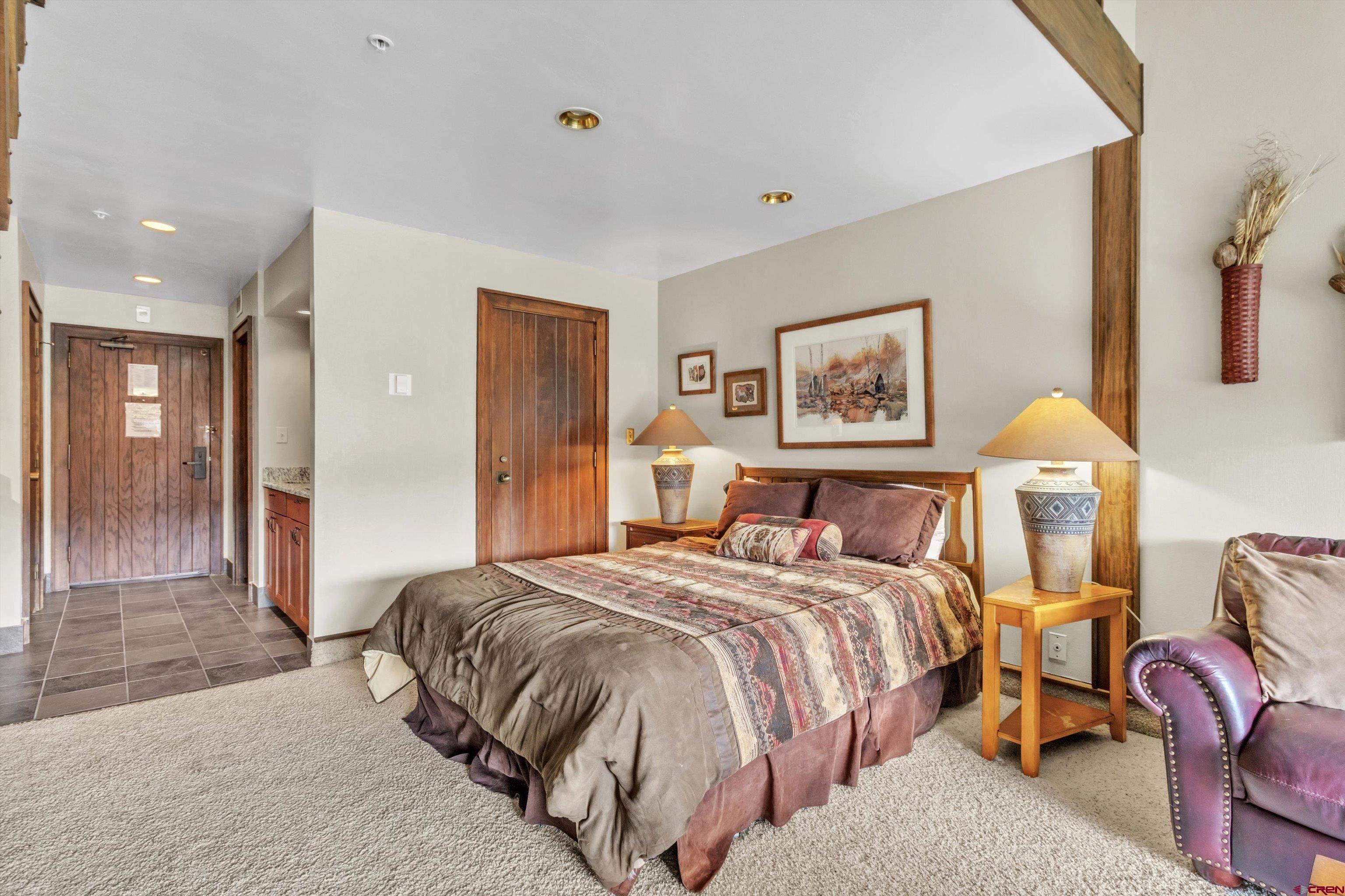 314 Tamarron Drive, Unit 511 Durango, CO 81301 - Photo 6 of 36 a spacious bedroom with a bed and glass walk in closet
