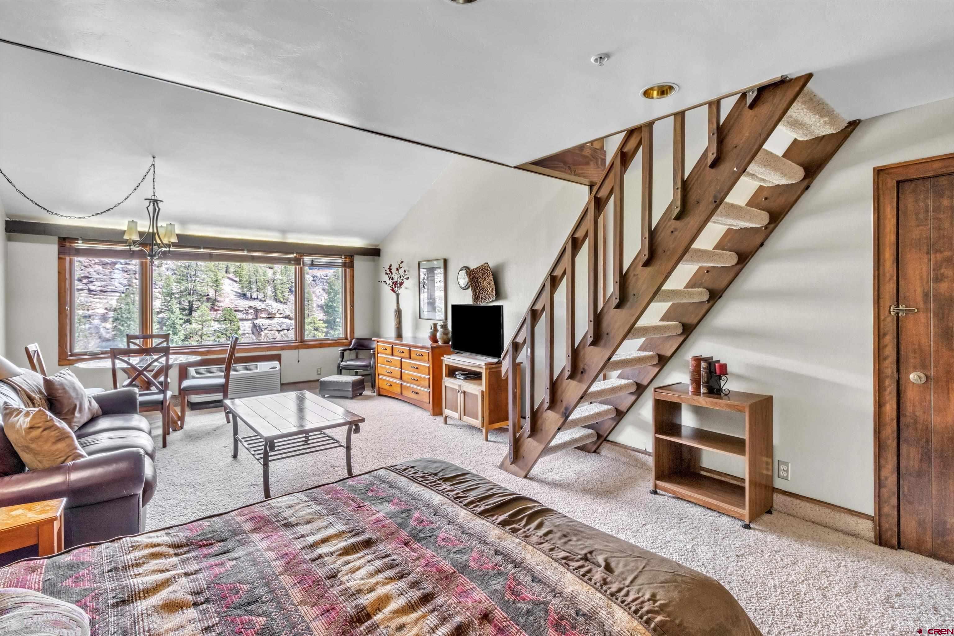 314 Tamarron Drive, Unit 511 Durango, CO 81301 - Photo 7 of 36 a living room with furniture or stairs and a wooden floor