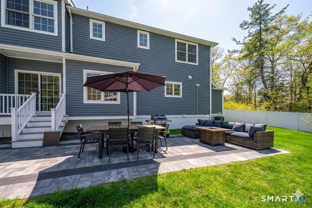 9 Sunset Ridge Drive Guilford, CT 06437 - Photo 36 of 40 a backyard of a house with table and chairs