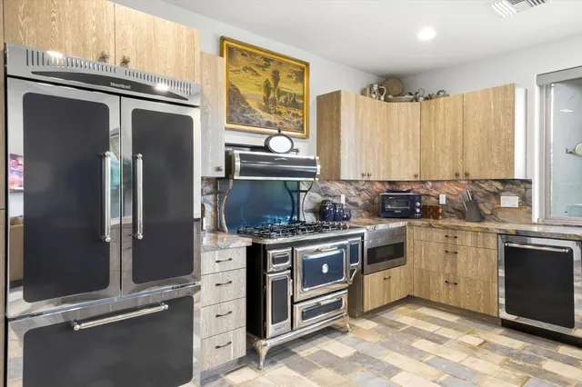 a stove top oven sitting inside of a kitchen