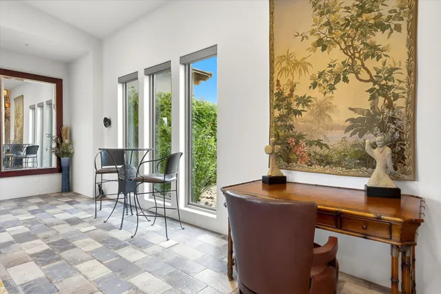 a bedroom with a bed and a flat tv screen on dresser