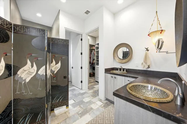 a bathroom with a shower and a sink