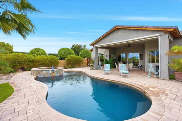 a view of a patio with a table chairs potted plants with wooden fence