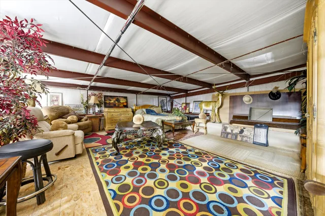 a bed room with a bed a television and dresser