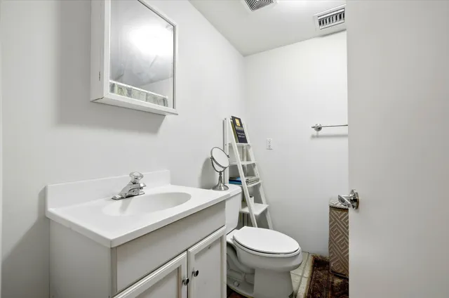 a spacious bedroom with a bed and a chandelier
