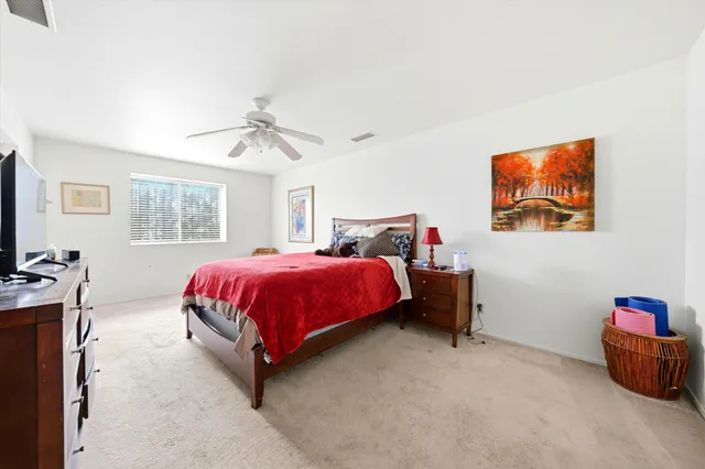 a kitchen with stainless steel appliances a table chairs refrigerator and microwave