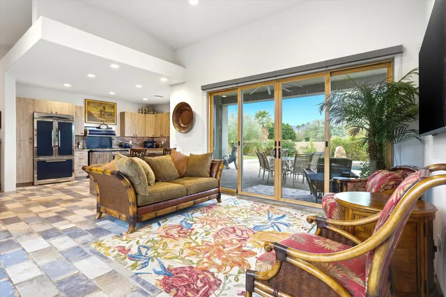 a living room with furniture and a floor to ceiling window