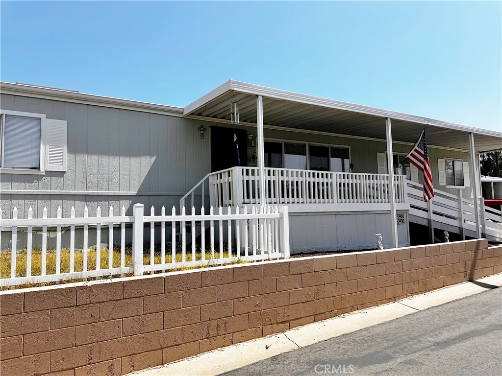 2140 Mentone Boulevard, Unit 97 Mentone, CA 92359 - Photo 2 of 29 a view of house with a deck