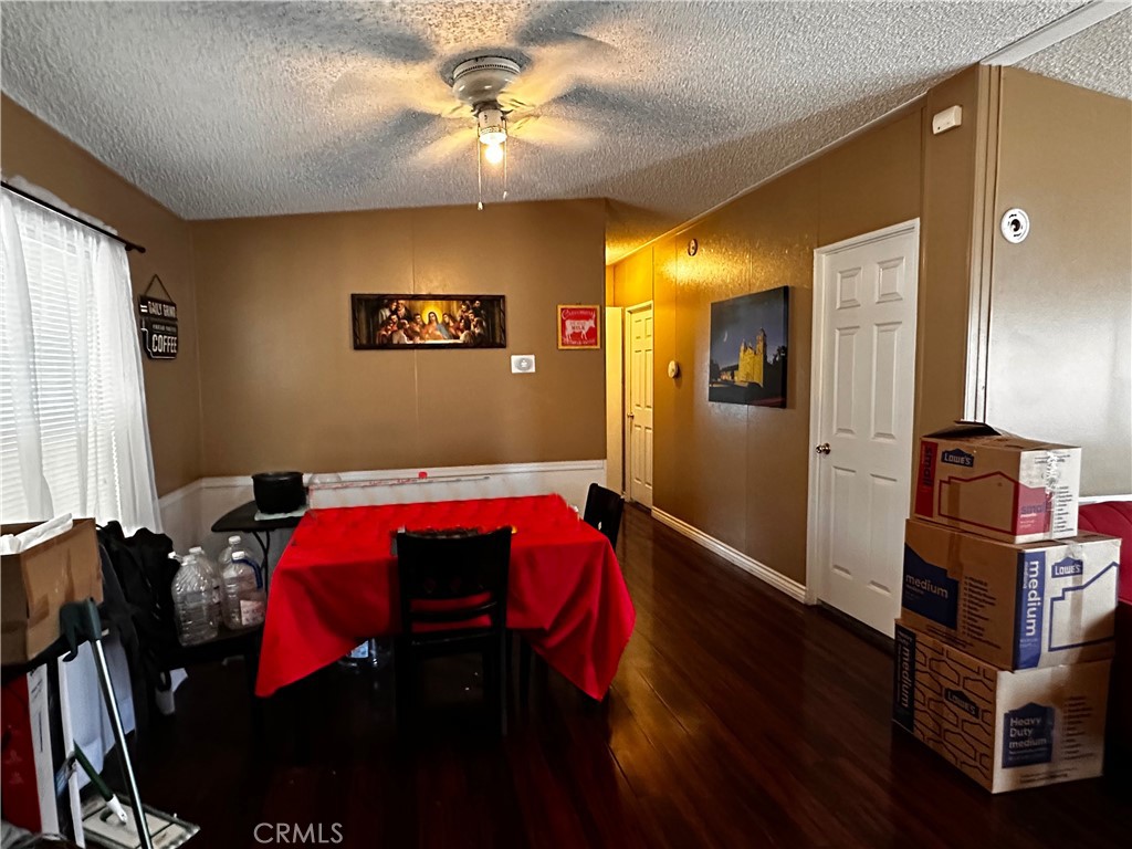 2140 Mentone Boulevard, Unit 97 Mentone, CA 92359 - Photo 7 of 29 a living room with furniture and a chandelier