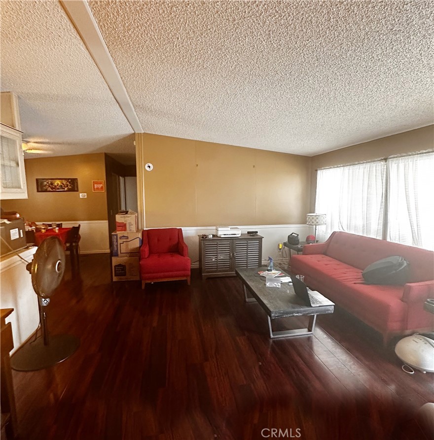 2140 Mentone Boulevard, Unit 97 Mentone, CA 92359 - Photo 8 of 29 a living room with furniture and a large window