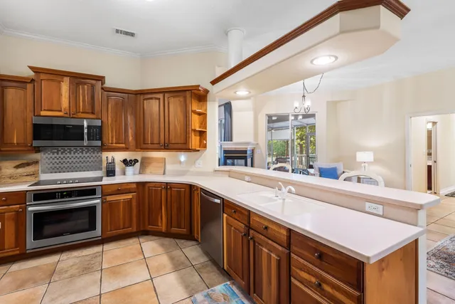 a kitchen with a sink stove and microwave