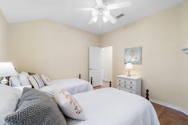 a bedroom with two beds and a chandelier