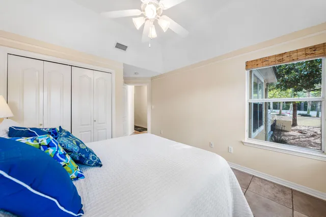 a bedroom with a bed and a large window