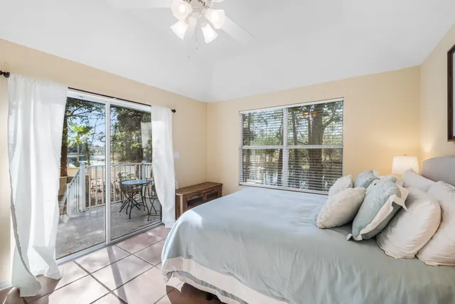 a bedroom with a bed and a large window with outer view