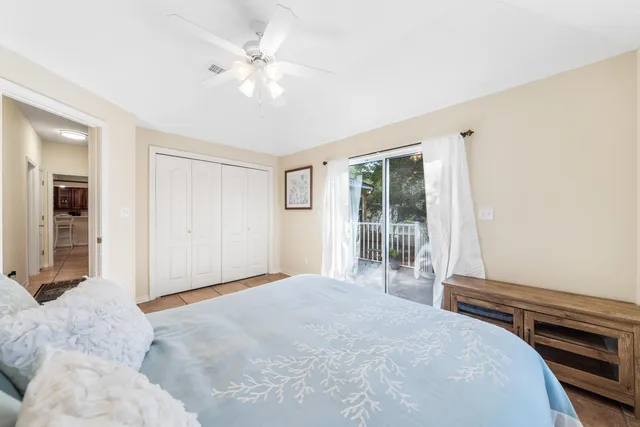 a large bed sitting in a bedroom next to a window