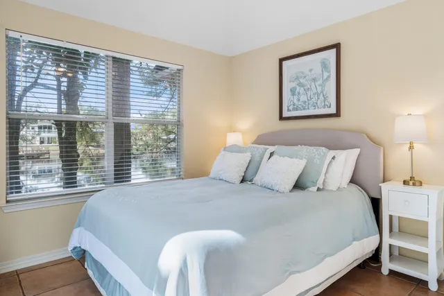 a living room with furniture potted plant and a large window