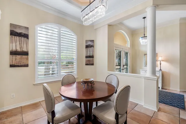 a living room with furniture a table and kitchen view