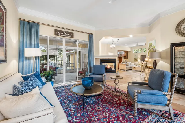 a living room with furniture potted plant and a large window