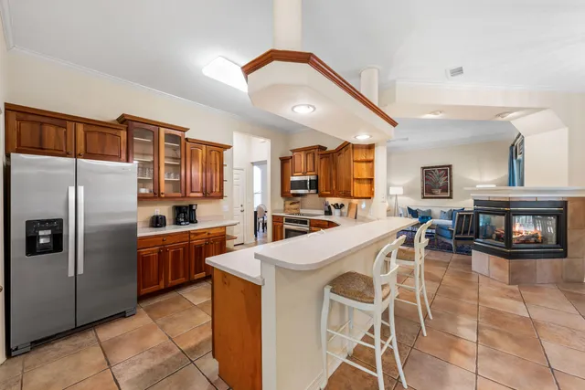 a kitchen with stainless steel appliances granite countertop a refrigerator and a stove top oven