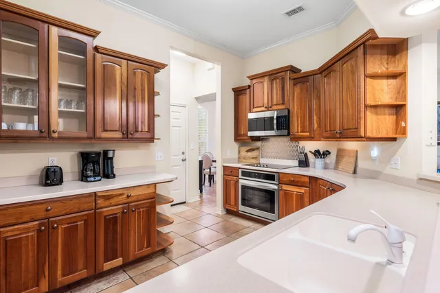 a kitchen with stainless steel appliances granite countertop a sink stove microwave and cabinets