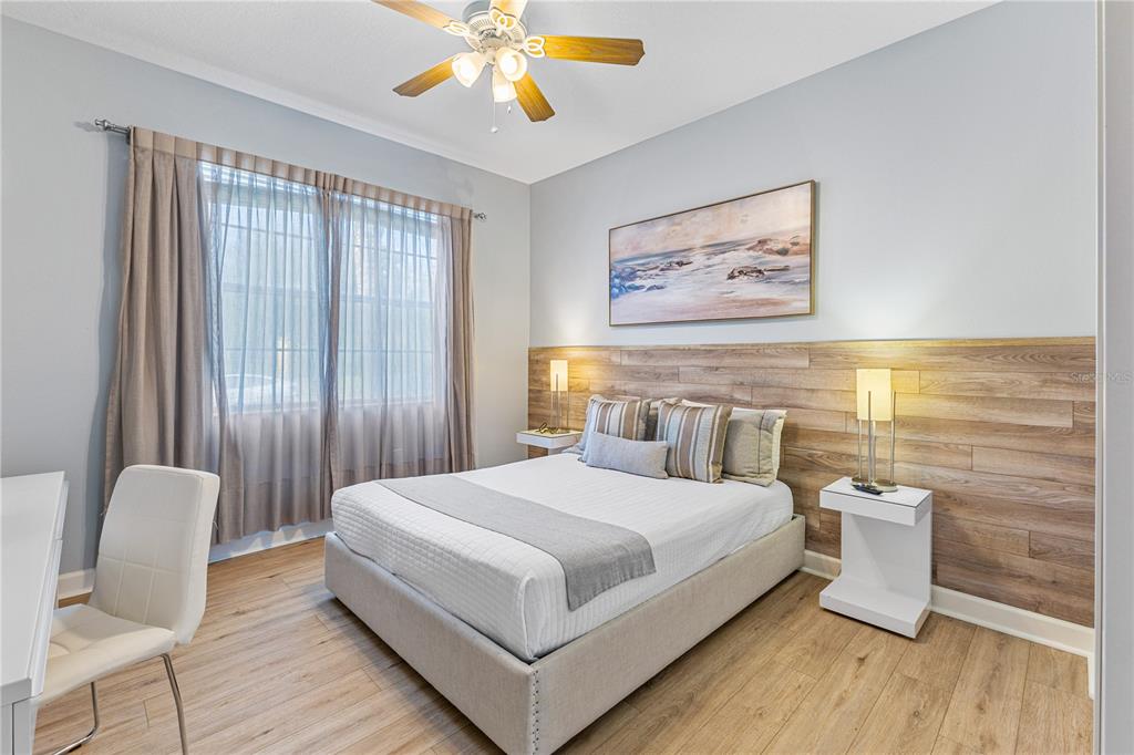 9006 Majesty Palm Road Kissimmee, FL 34747 - Photo 7 of 56 a bedroom with a large bed and a chandelier