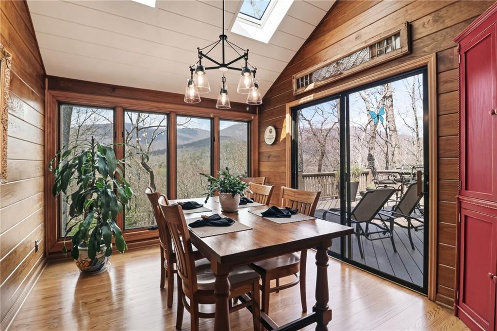 115 Chestnut Oak Point Big Canoe, GA 30143 - Photo 11 of 56 a view of a dining room with furniture large windows and wooden floor