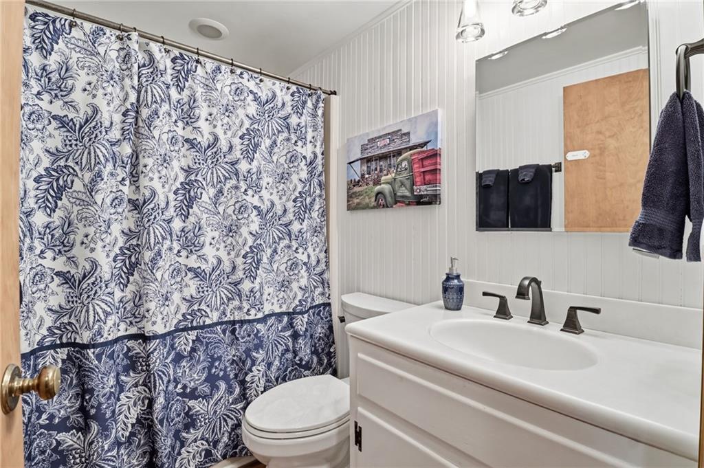 115 Chestnut Oak Point Big Canoe, GA 30143 - Photo 16 of 56 a bathroom with a toilet sink and mirror