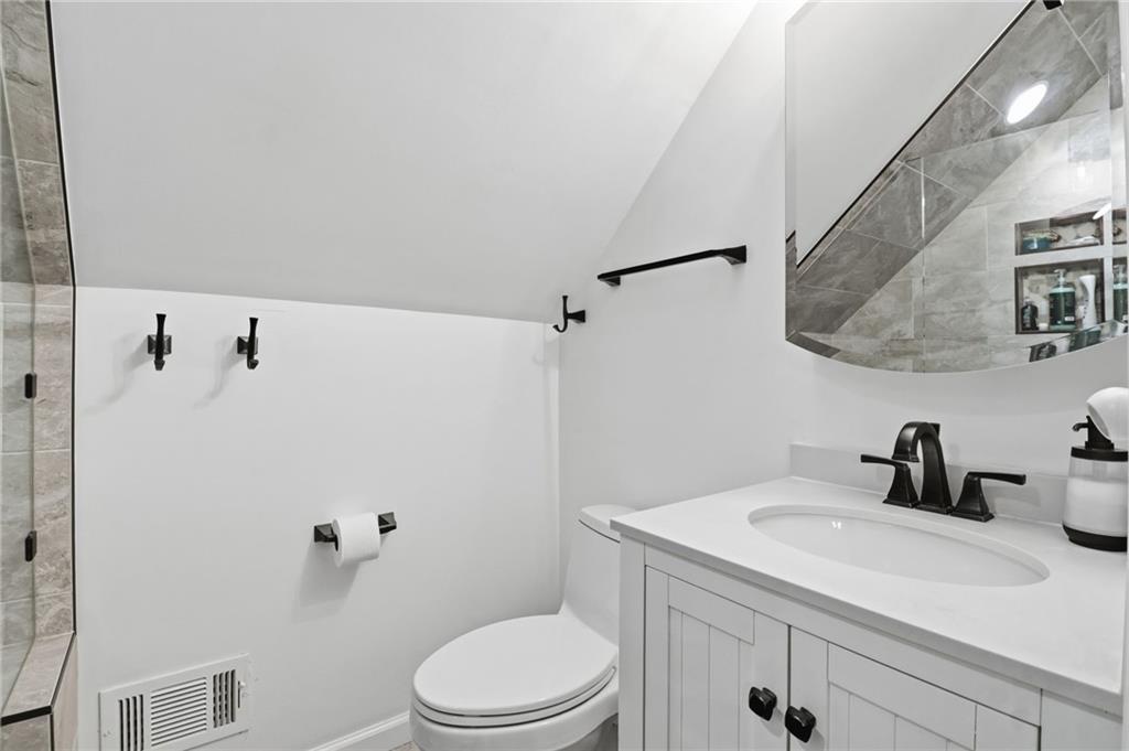 115 Chestnut Oak Point Big Canoe, GA 30143 - Photo 19 of 56 a bathroom with a sink a toilet and shower