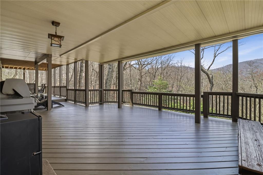 115 Chestnut Oak Point Big Canoe, GA 30143 - Photo 26 of 56 a view of a room with lots of wooden furniture and floor to ceiling window