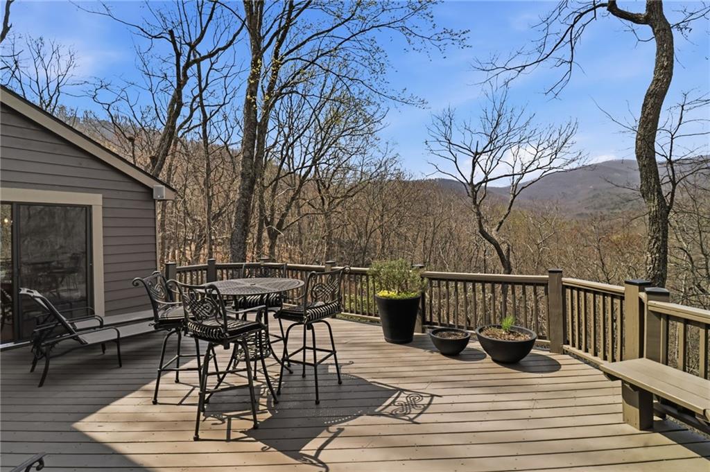 115 Chestnut Oak Point Big Canoe, GA 30143 - Photo 32 of 56 a view of backyard with table and chairs and wooden floor