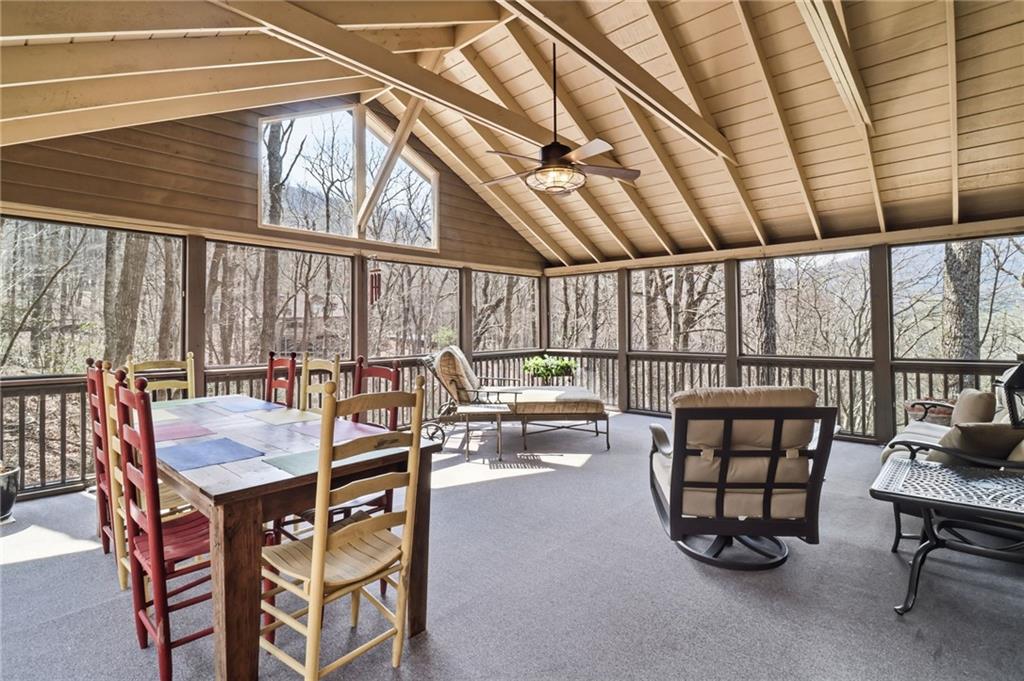 115 Chestnut Oak Point Big Canoe, GA 30143 - Photo 10 of 56 a dining room with furniture and a floor to ceiling window
