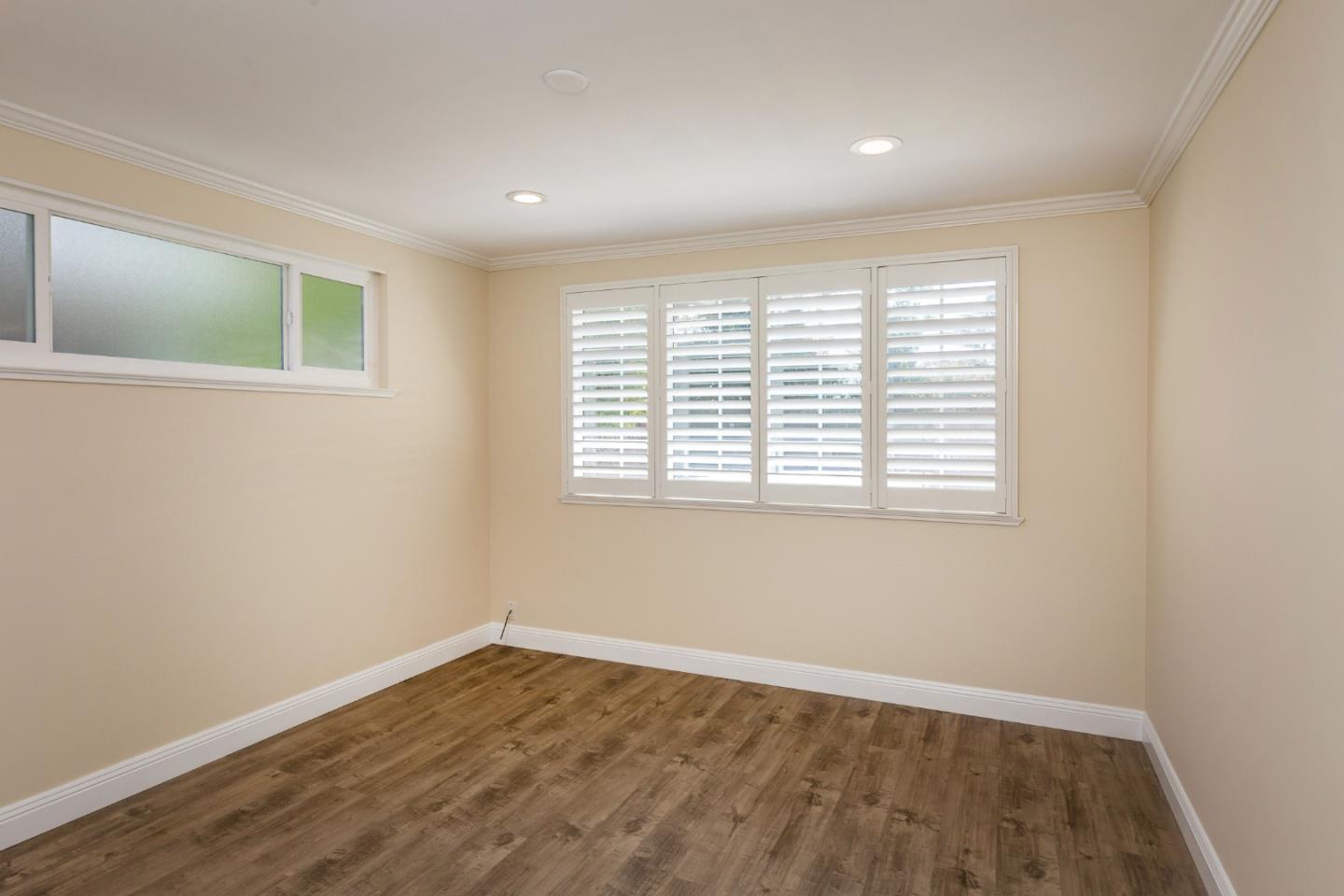 552 Marsh Road Menlo Park, CA 94025 - Photo 15 of 22 an empty room with wooden floor and windows
