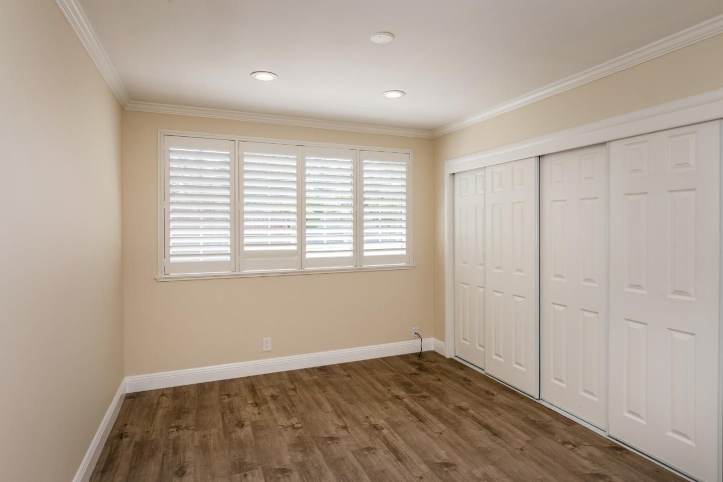 552 Marsh Road Menlo Park, CA 94025 - Photo 16 of 22 an empty room with wooden floor and windows